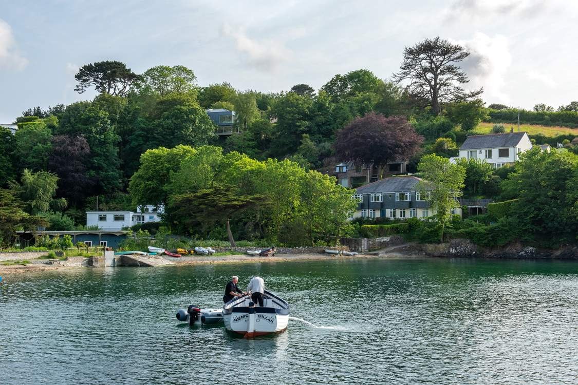 Gillan Cove beach seen from the water, with Carne Haven among the trees above